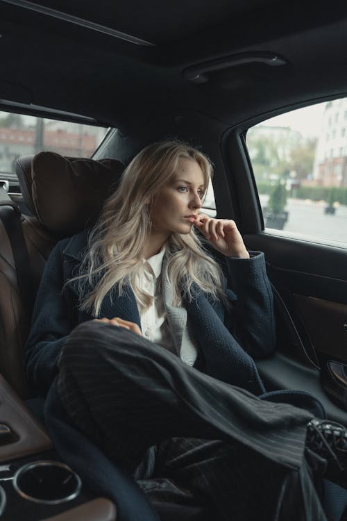 Free Woman In A Coat Inside A Car Stock Photo