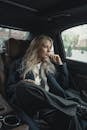 Woman In A Coat Inside A Car