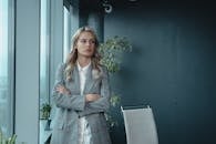 一位职业女商人自信地站在现代办公室里，散发着领导力和决心