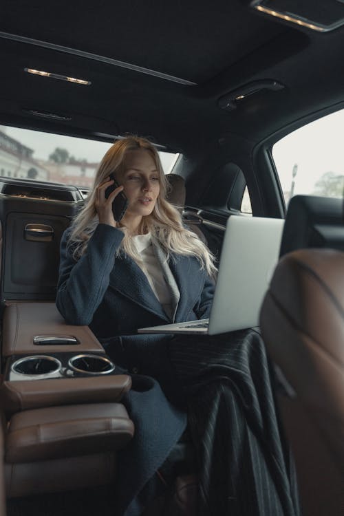 Free Woman in Gray Business Suit Sitting In A Luxurious Car Stock Photo