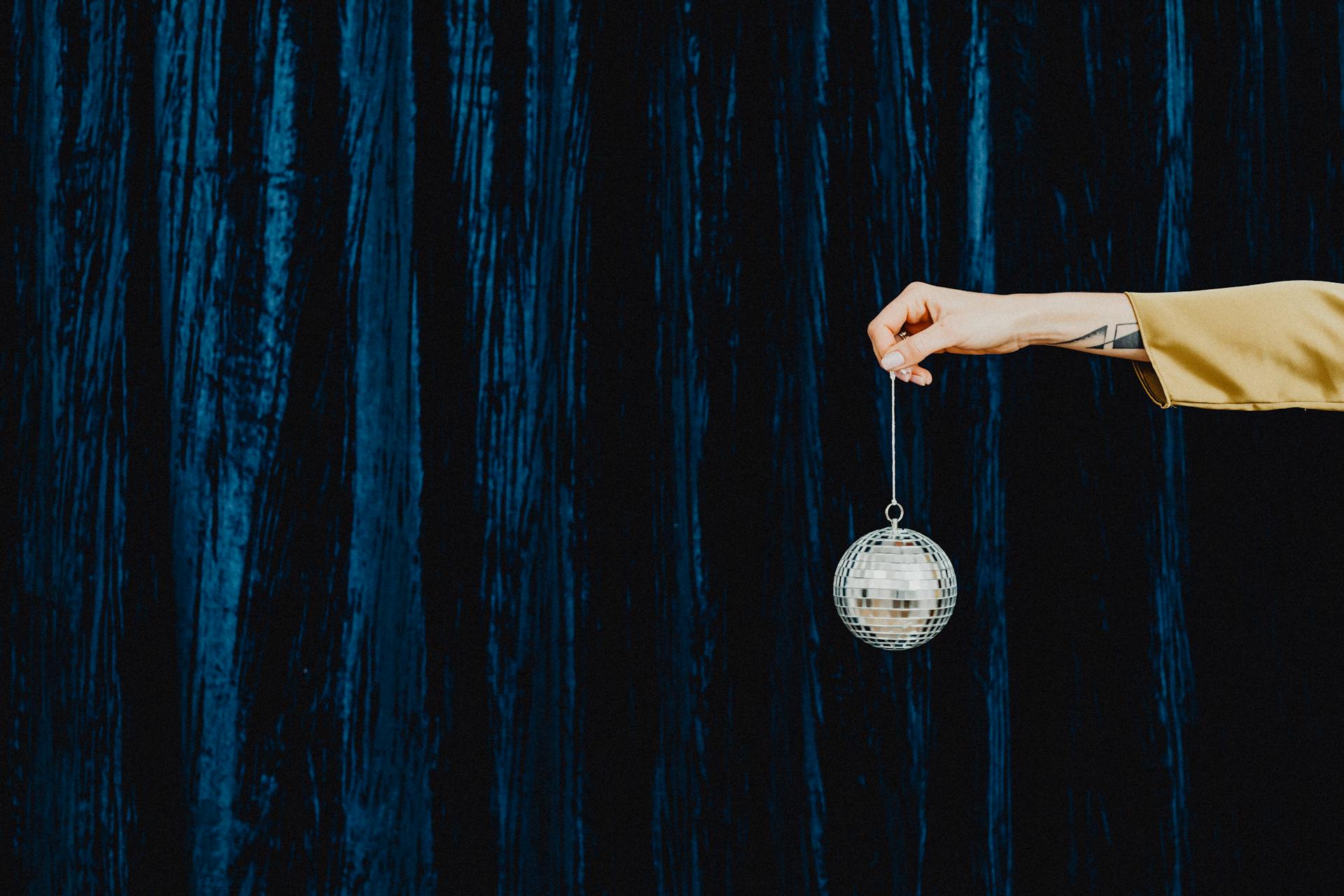 A Person Holding a Disco Ball