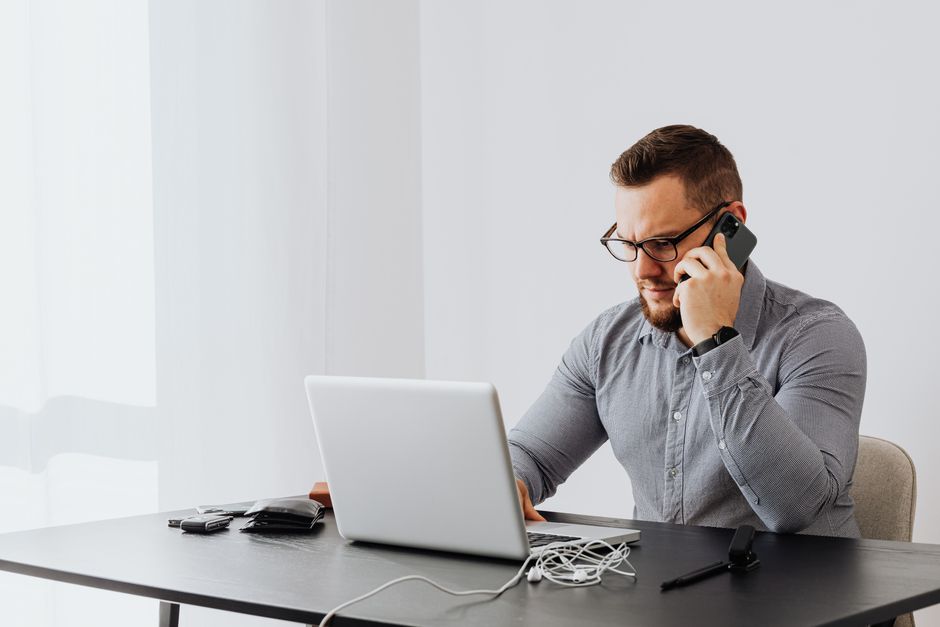 salesperson laptop phone office desk
