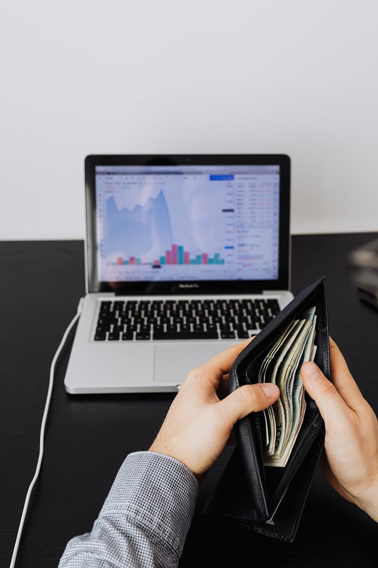 A Person Holding His Wallet