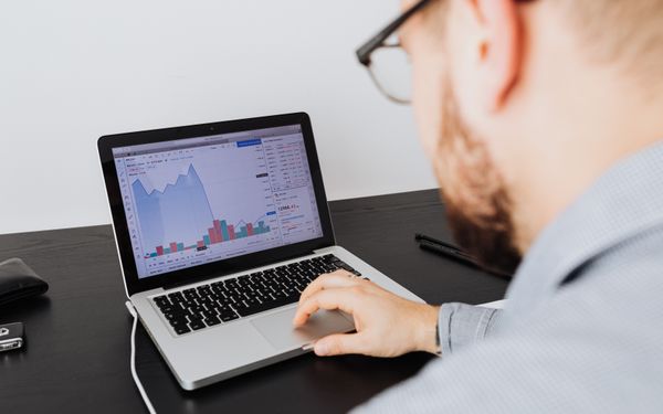 Marketer reviewing a search performance chart on his laptop