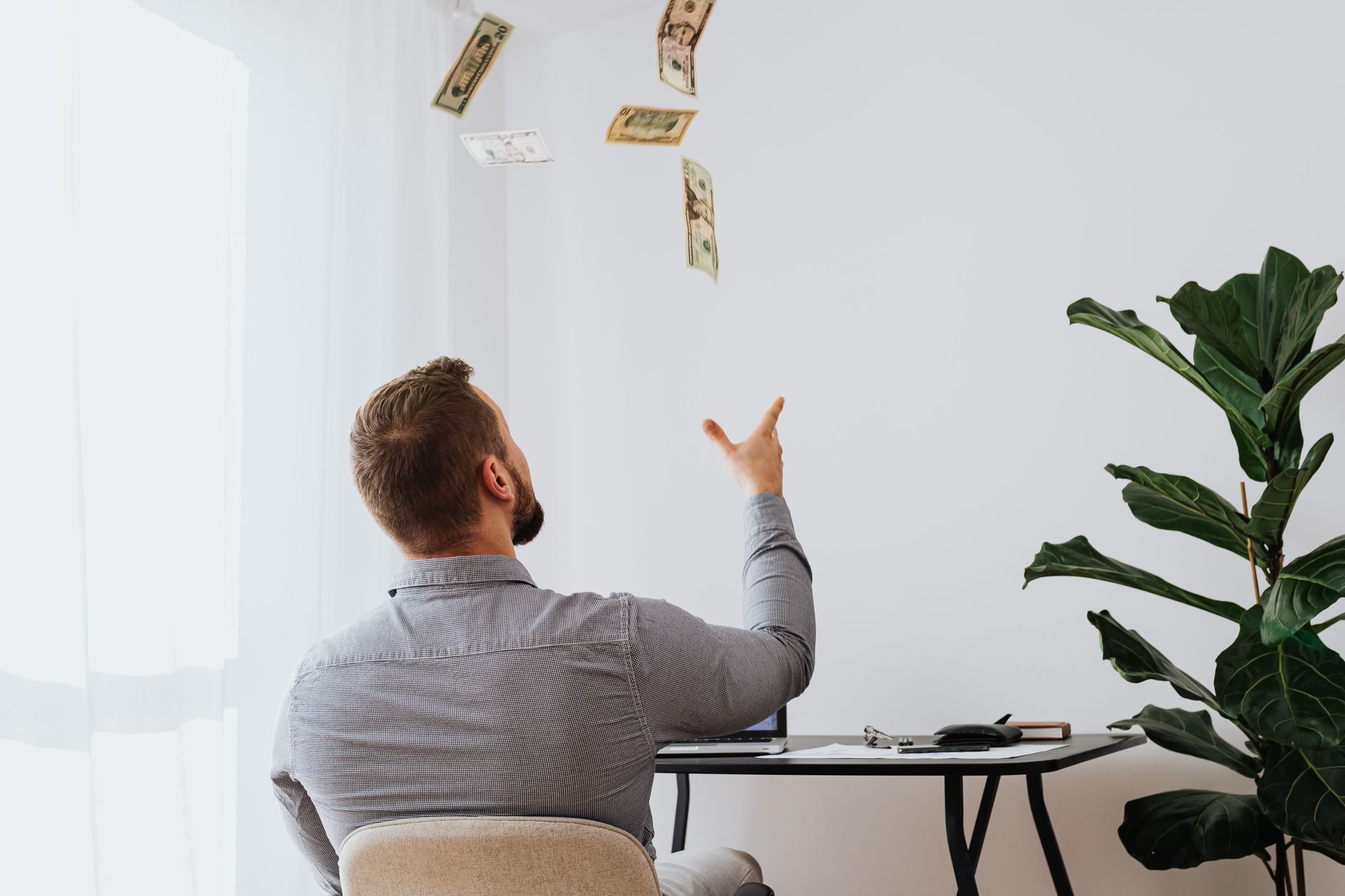 Accounting Software for Freelancers: Simplify Your Finances 7 Freelancer celebrating financial success, looking at a laptop with charts