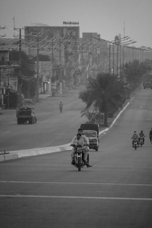 Grayscale Photo of Motorcycles on the Road