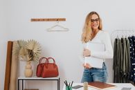 Woman in White Long Sleeves Carrying a Silver Laptop