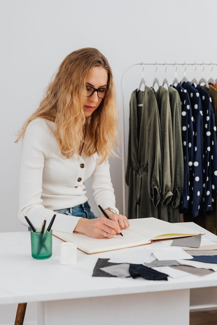 A studio owner sketching designs at her worktable — photo by www.kaboompics.com on Pexels
