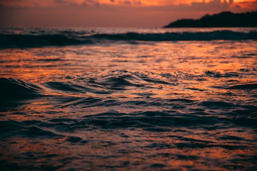 Experience the captivating sunset over the waves in Puerto Escondido, Mexico, capturing nature's vibrant beauty.