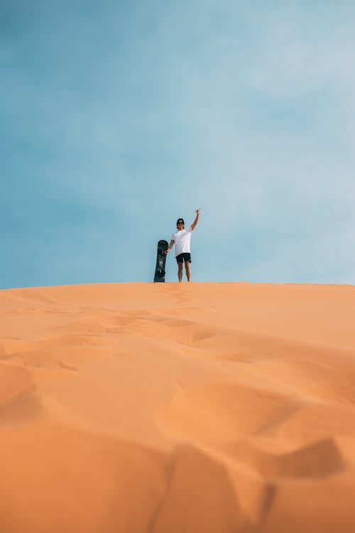 Free A Man Standing on the Desert Stock Photo