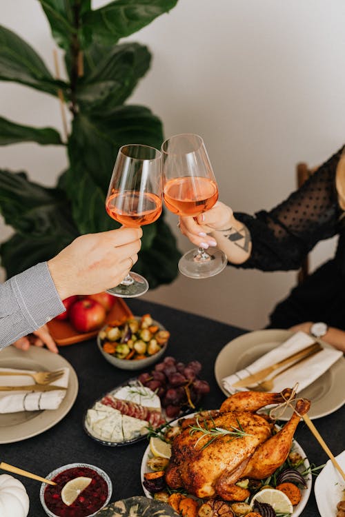 Person Holding Wine Glass With Red Wine