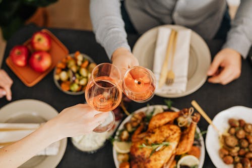 Food On The Table With Two People Having Wine