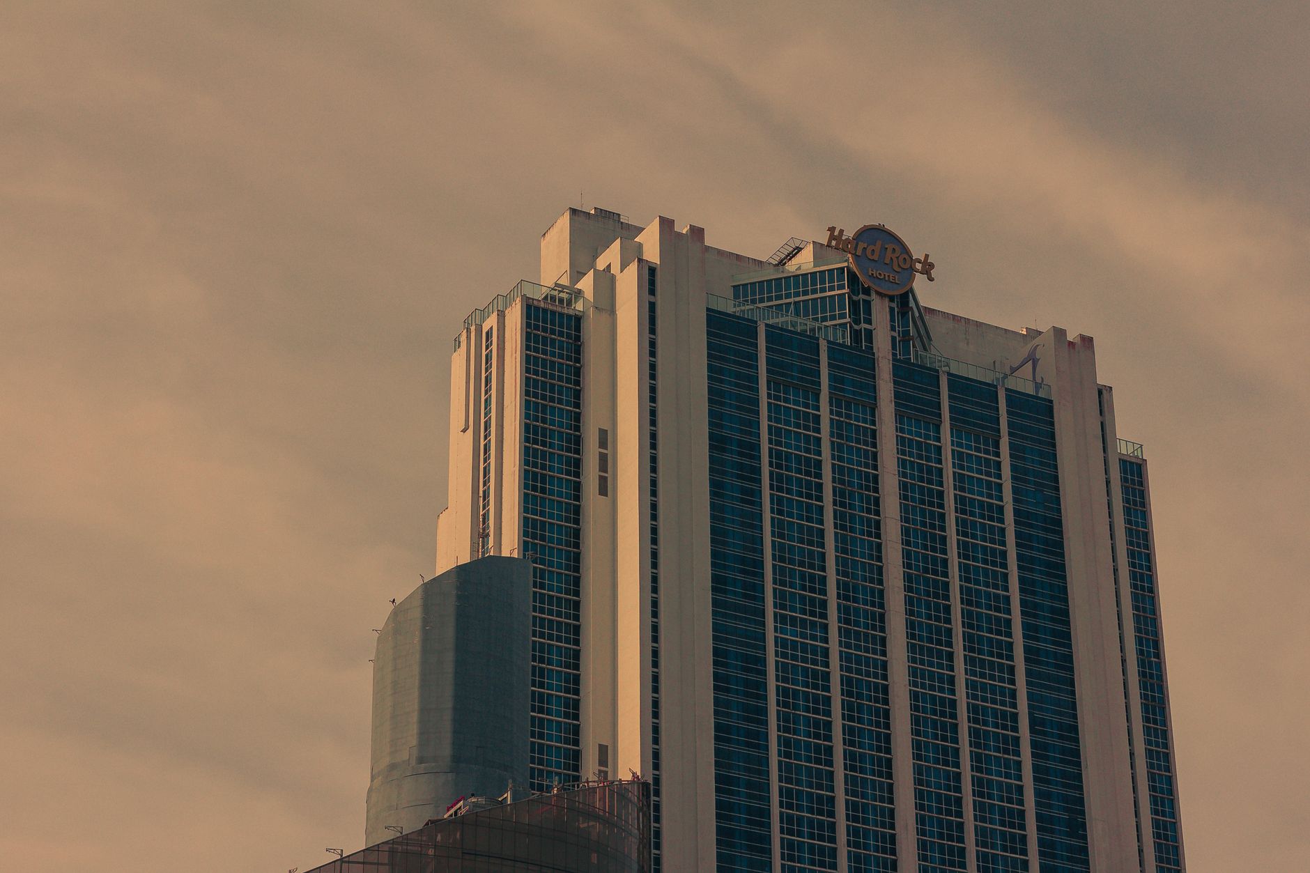 High-rise building featuring Hard Rock Hotel in an urban setting with clear skies.