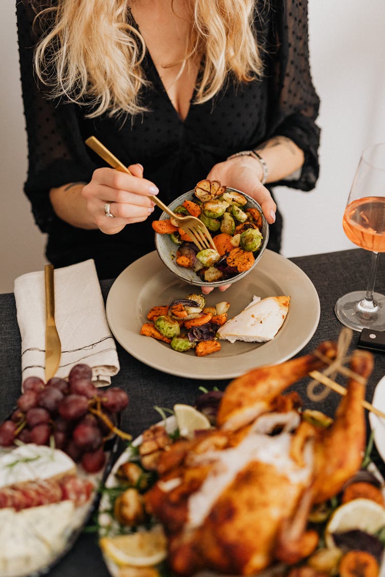 Woman Eating Dishes At Thanksgiving Dinner