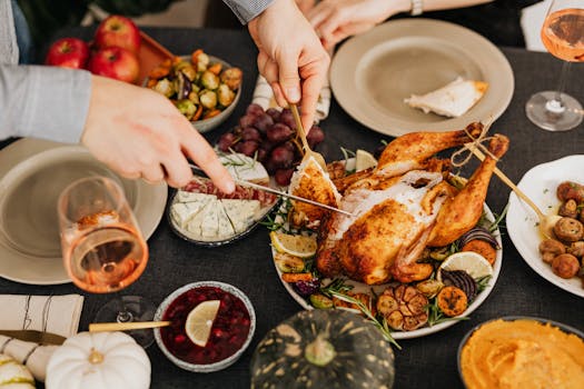 Top view of a festive table with roasted turkey, vegetables, and wine, perfect for Thanksgiving.
