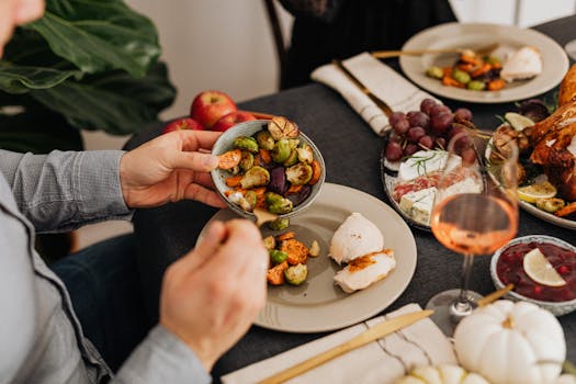 A cozy dinner setting featuring roasted vegetables, cheese, and wine, perfect for gatherings.