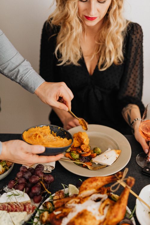 Free Close-up of a festive dinner with people enjoying a delicious meal together. Stock Photo