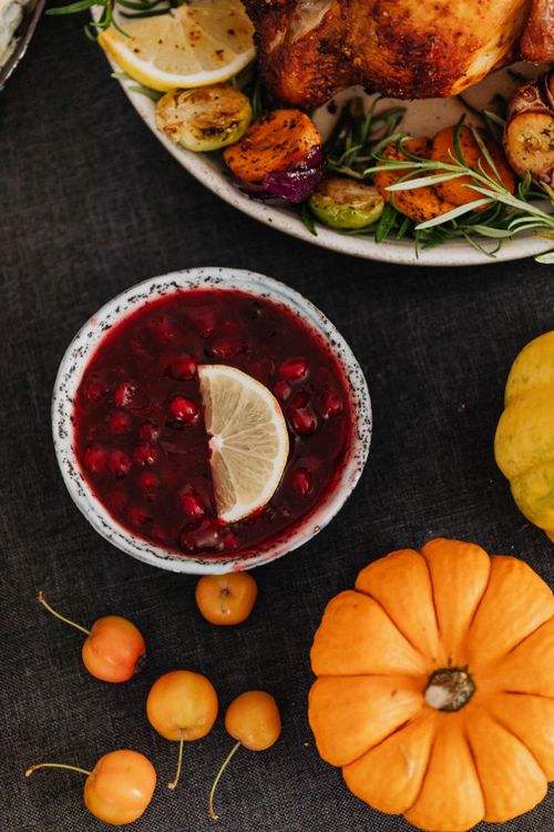 Free Autumnal still life with cranberry sauce, pumpkins, and seasonal vegetables for a festive meal. Stock Photo