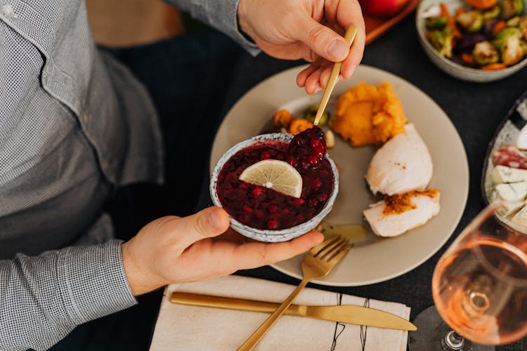 Hands Of Man Eating Dessert