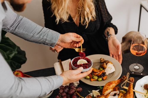 Free A couple enjoys a sophisticated dinner with gourmet dishes and wine. Stock Photo