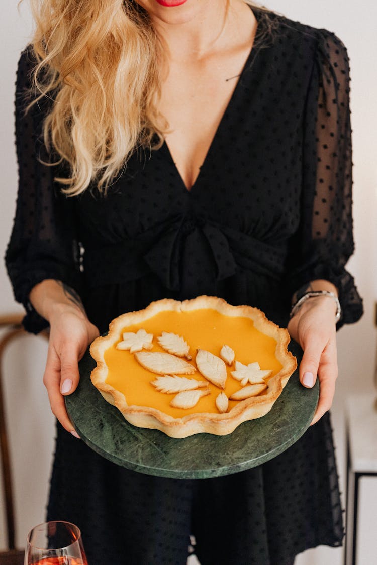 Woman Serving A Pumpkin Pie 