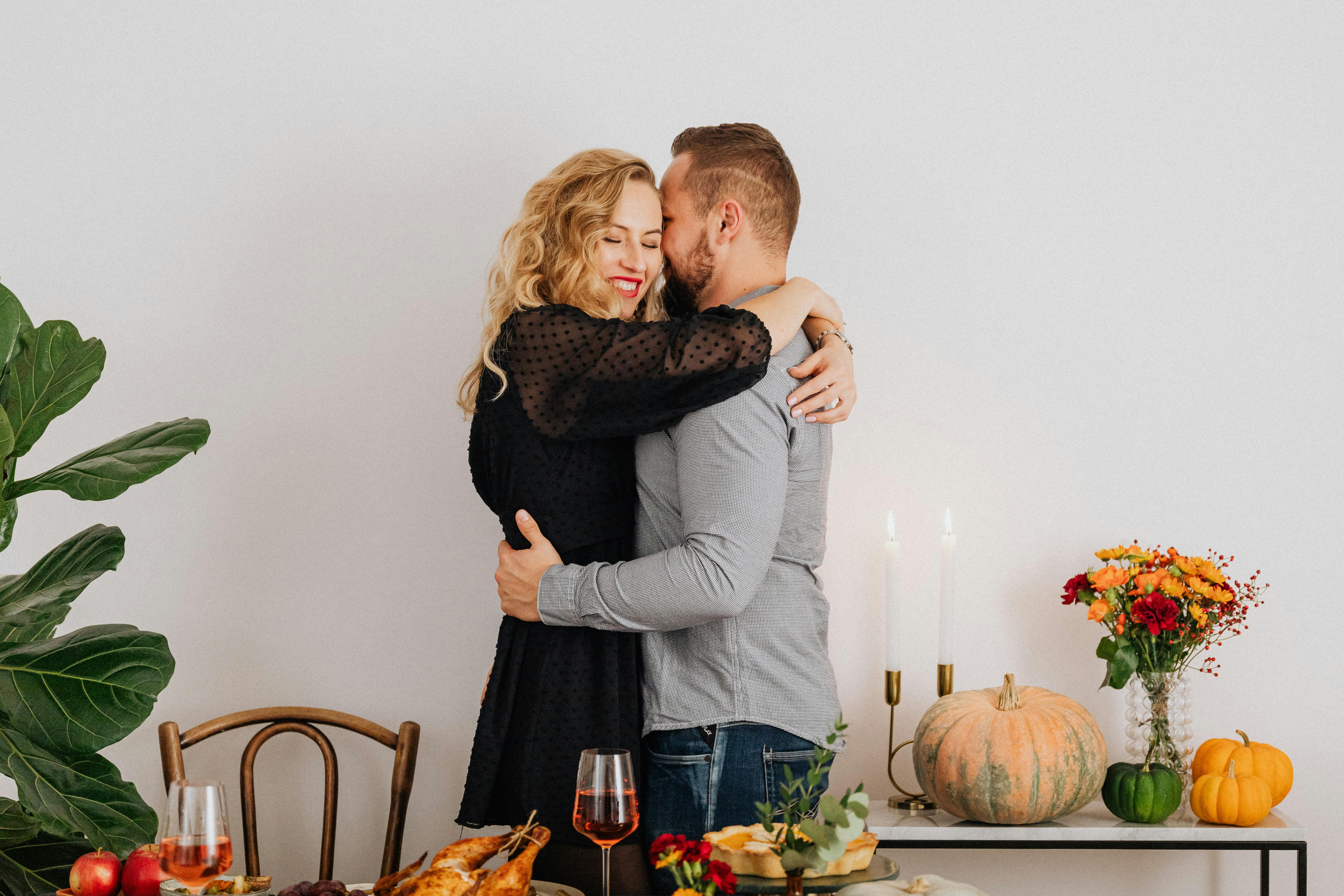 image of a couple sharing a warm moment, expressing gratitude at a cozy table
