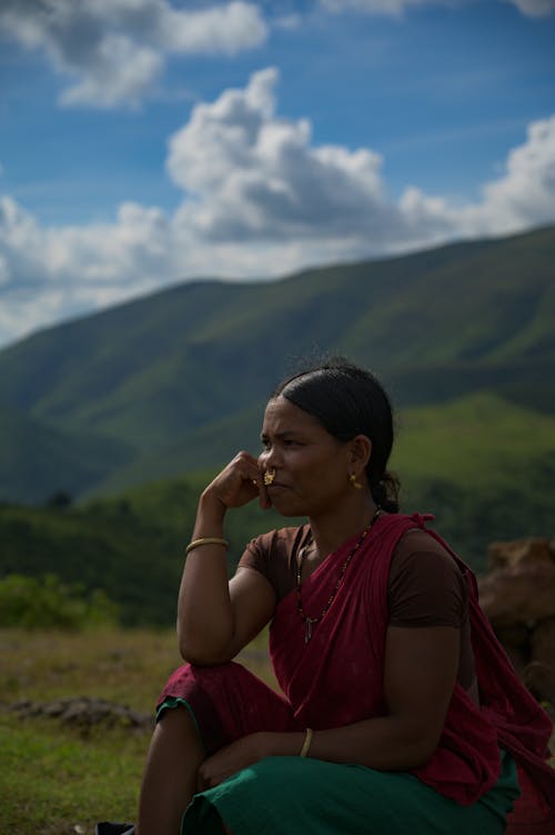 Woman in Pensive Pose against Mountains