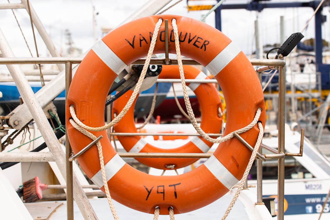 Free Orange Lifebuoy on a Silver Metal Fence Stock Photo