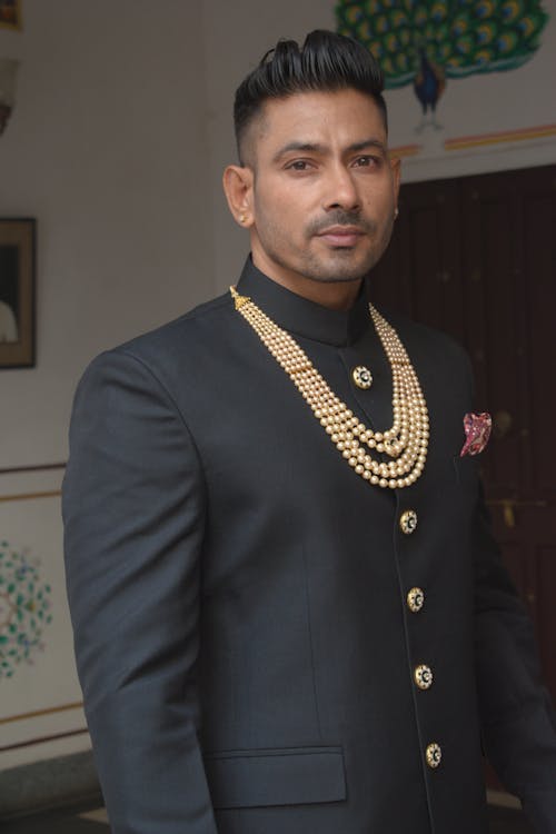 Man in Black Suit with Gold Necklace