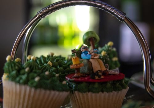 Free Close-up of decorative cupcakes featuring a miniature crafted scene, showcasing intricate sugar artistry. Stock Photo