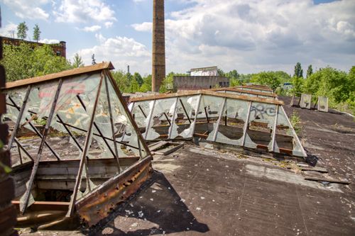 Free Sunlit view of a decaying rooftop with broken glass panels in Leipzig, highlighting urban decay. Stock Photo