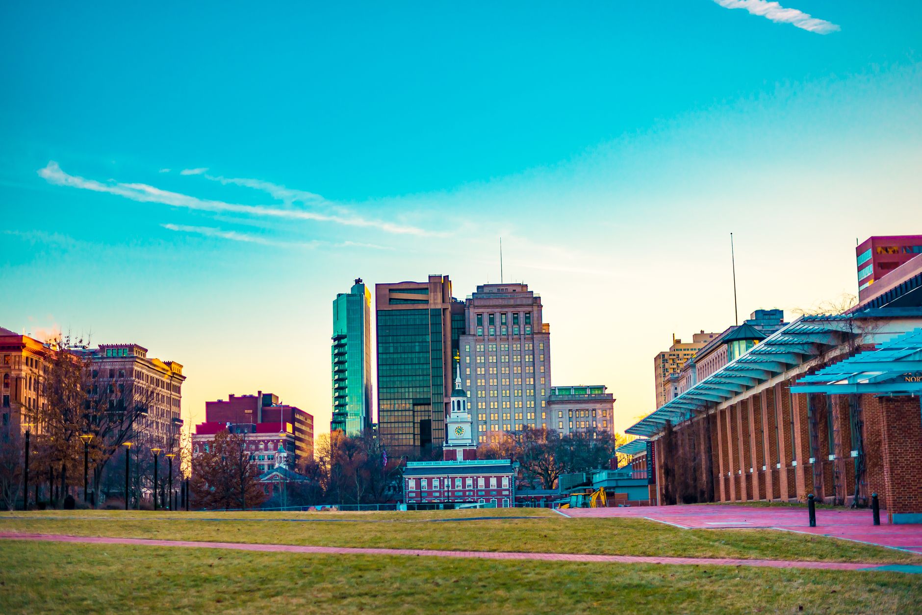 A stunning view of Philadelphia's urban skyline with historic buildings and modern architecture at sunset.