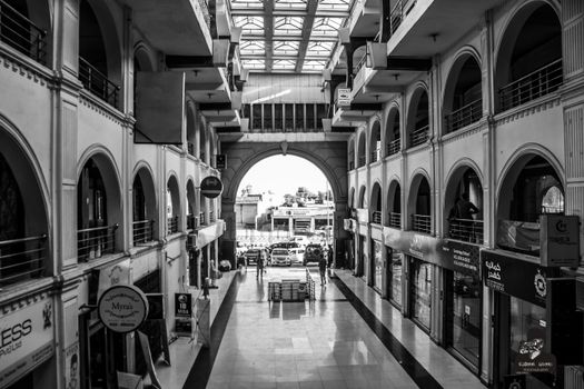 Black and white view of a shopping mall interior with architectural arches in Peshawar, Pakistan.