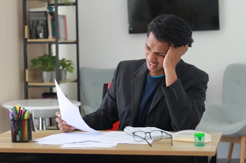 A Man in Black Suit Jacket Holding a Paper