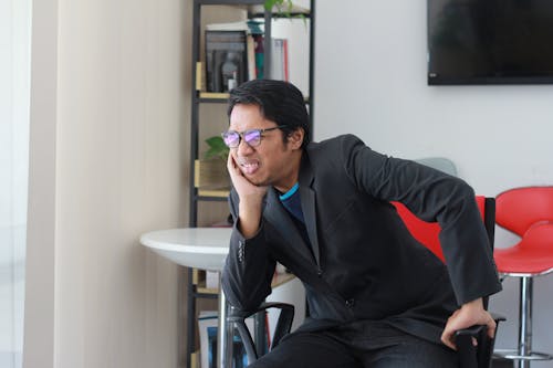 Free A Man in Black Suit Sitting inside the Office Stock Photo