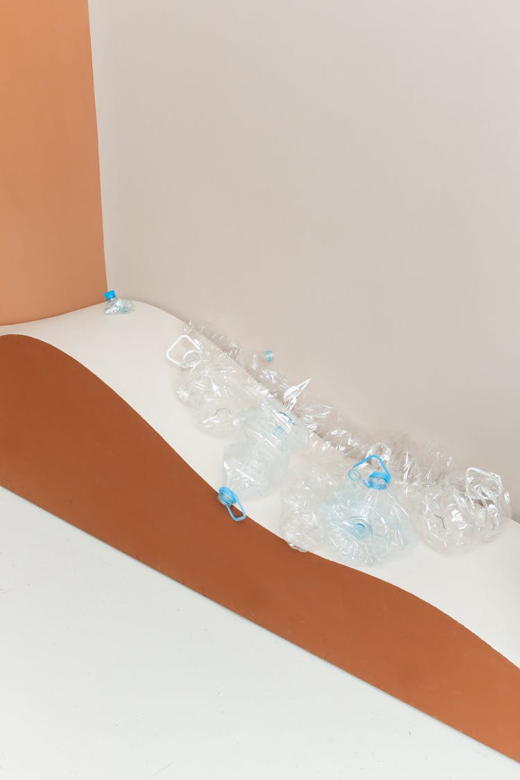 Empty Clear Plastic Bottles On Brown And White Surface