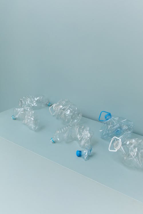 Clear Plastic Bottles on White Table