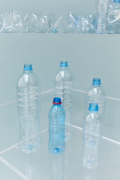 Transparent Plastic Bottles on the White Table