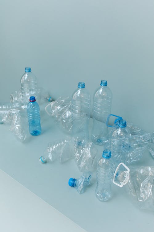 Blue Plastic Bottles on White Table