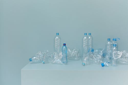 Blue Plastic Bottles on White Table
