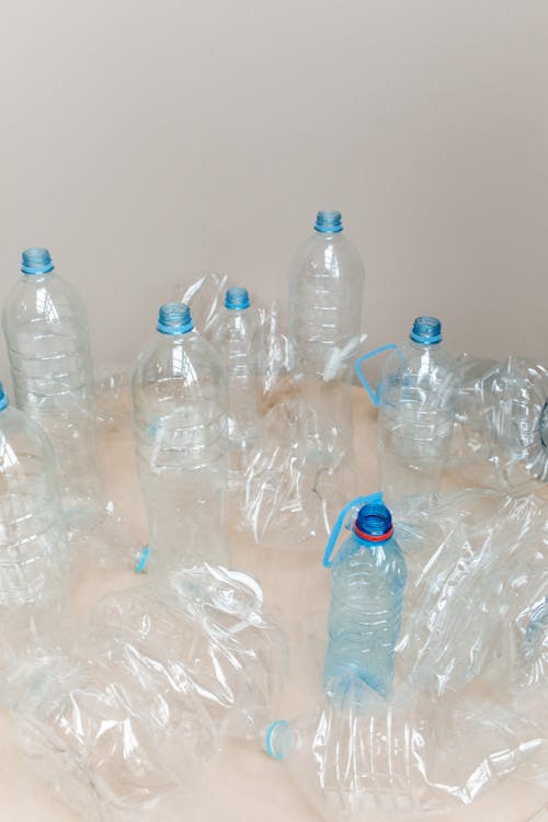 Clear Plastic Bottle on Brown Wooden Table