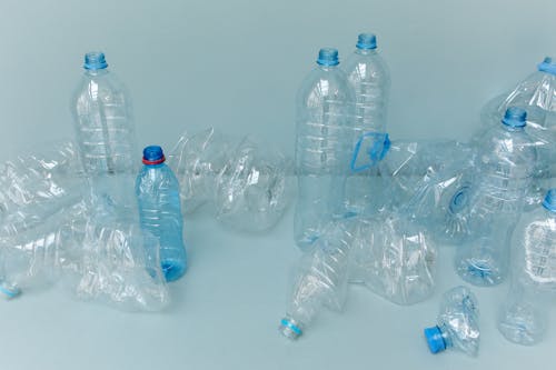 Clear Plastic Bottles on White Table