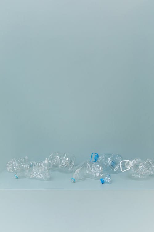 Blue and Clear Plastic Bottle on White Surface