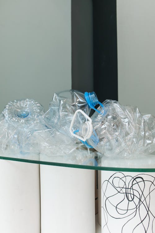 Clear Plastic Bottles on Glass Table