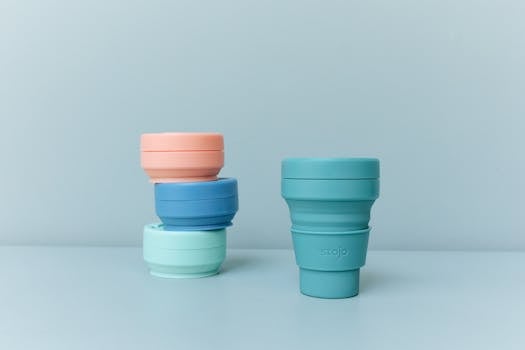 Colorful reusable and collapsible cups promoting sustainability and zero waste living.