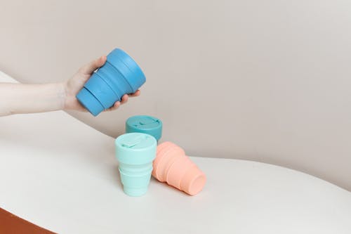 Close-Up Shot of a Person Holding a Collapsible Cup