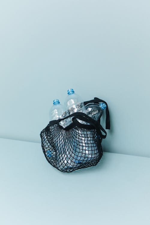 Close-Up Shot of Plastic Bottles in a Net