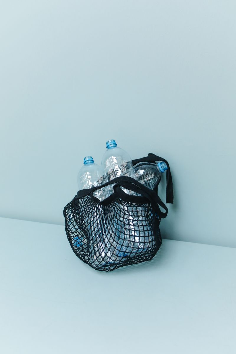 Close-up of plastic bottles gathered in a net for recycling