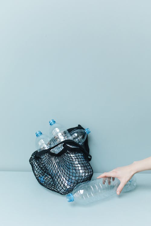 Close-Up Shot of a Person Holding a Plastic Bottle