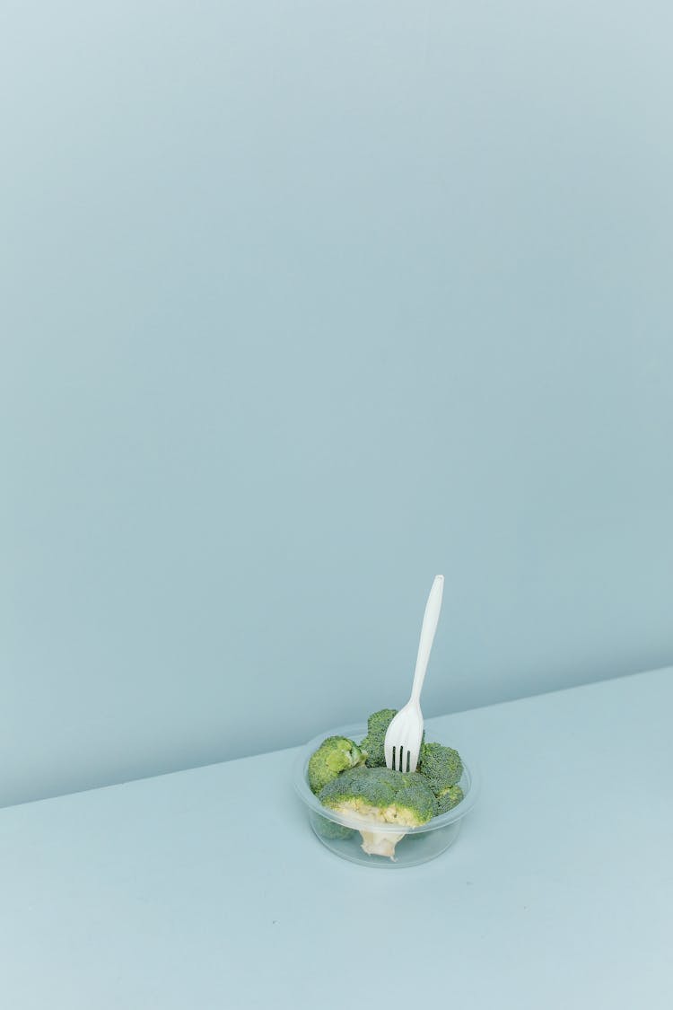 Sliced Broccoli On Plastic Container With Fork 